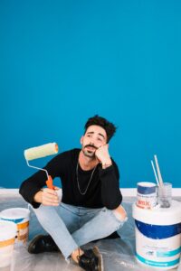 Pintor poco profesional preocupado porque sabe que no va a cumplir lo pactado con su cliente